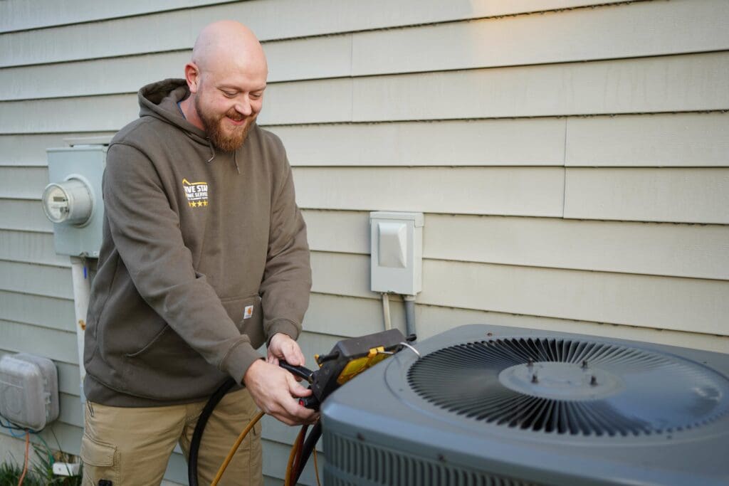 five star technician performing annual air conditioner maintenance