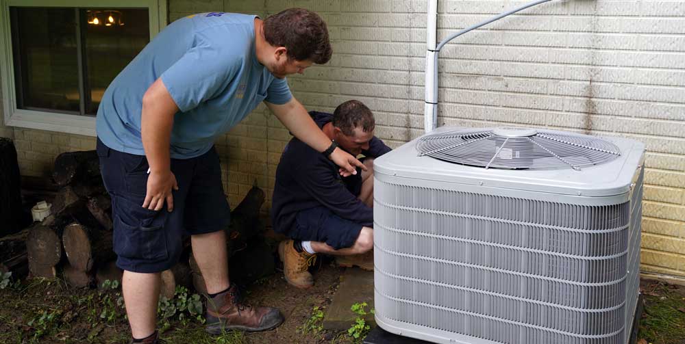 Two Five Star Home Services Techs Working on Air Conditioner