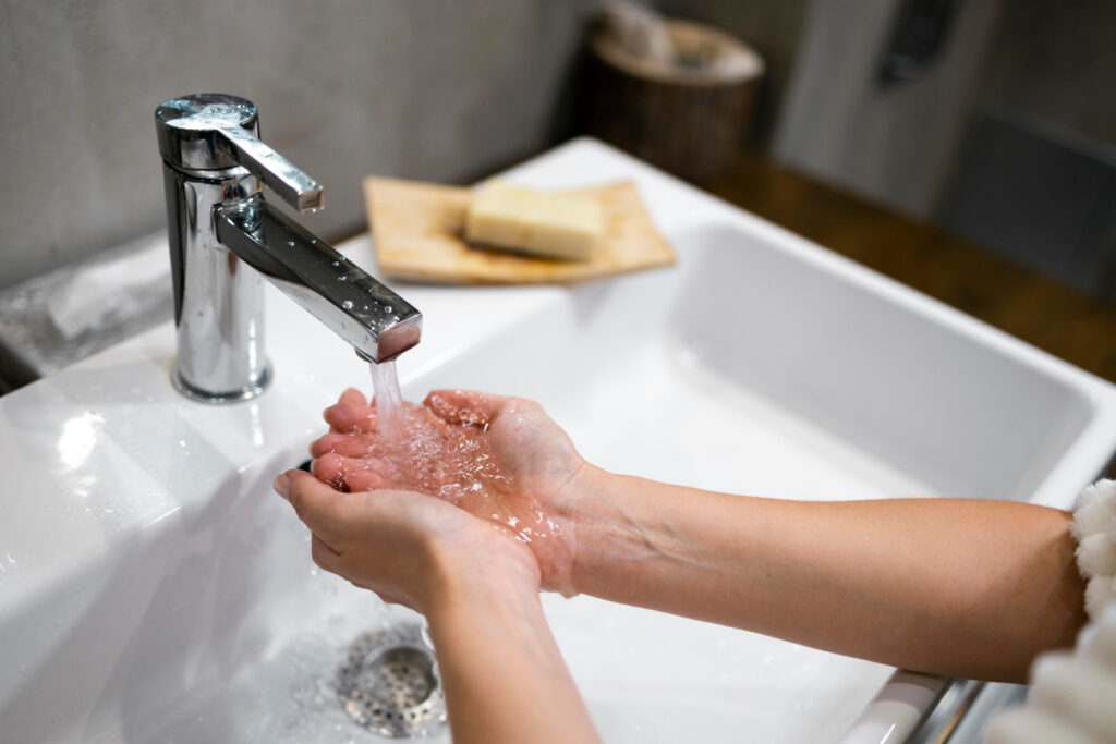 Woman washing hands in sink