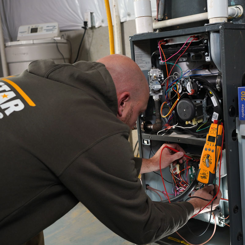 Technician fixing furnace