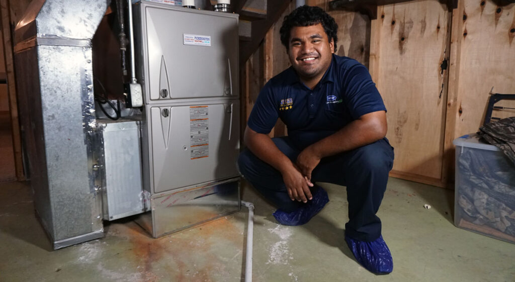 Technician next to a furnace