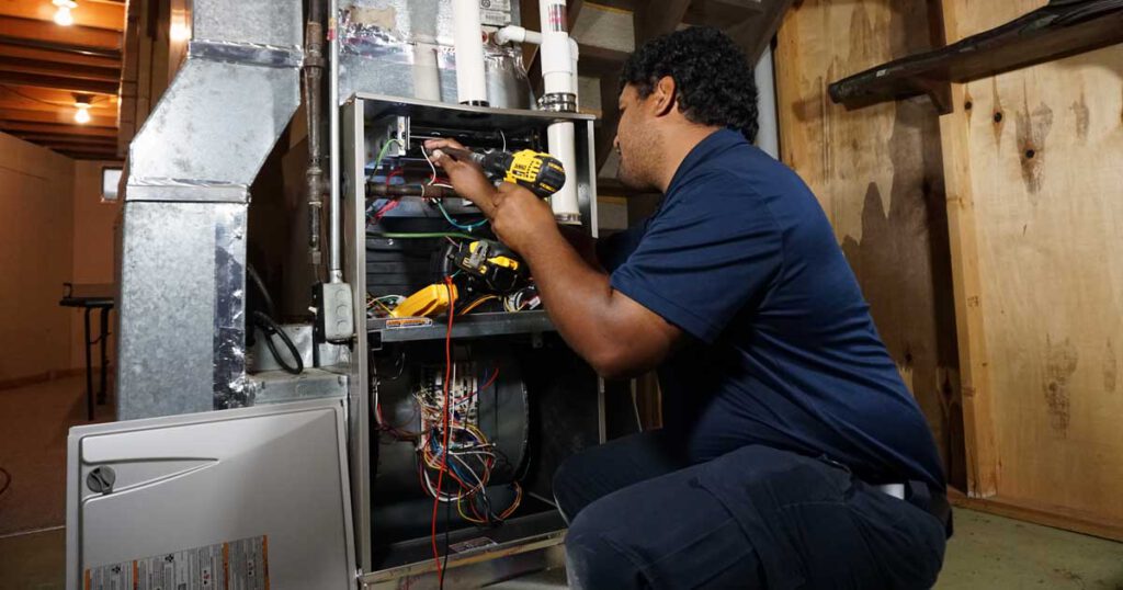 Technician repairing a furnace